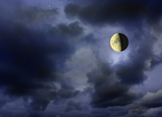 Naklejka na ściany i meble Moon glowing in the dark cloudy night sky