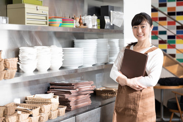 portrait of young asian waitress in cafe