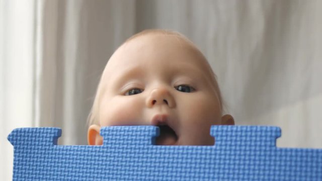 Baby plays with eva puzzle mat