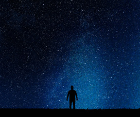 Fototapeta na wymiar Silhouette of man on a background stars.