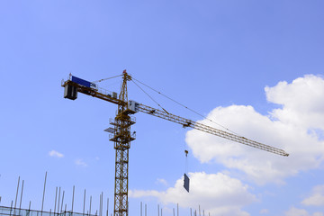 Crane in work, in the construction site