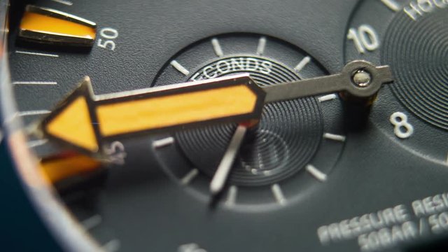 Time Flies. Diving Deep Sea Watch Close Up 4K Timelapse.
Time is running out. Close-up of watch with orange clock hands moving.
