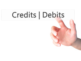 Credits  Debits - Hand pressing a button on blurred background concept on visual screen.