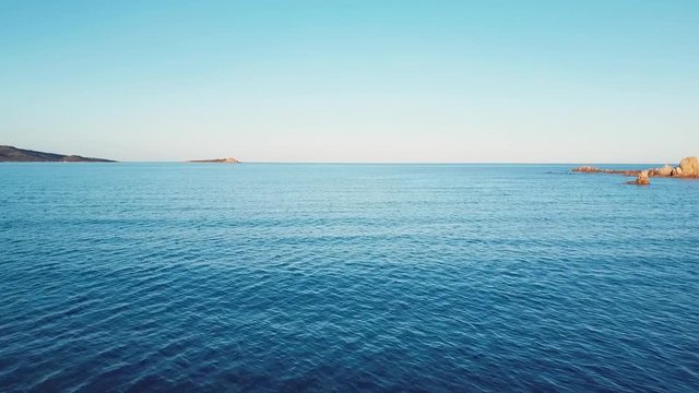 Aerial video shot by a drone of the Emerald Coast at sunset in Sardinia, Italy.