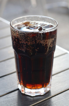 A Dark Cola Flavored Soda Pop on a Cafe Table