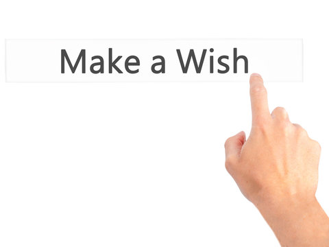Make a Wish - Hand pressing a button on blurred background concept on visual screen.