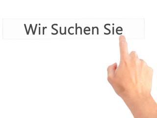 Wir Suchen Sie! (Looking For You in German) - Hand pressing a button on blurred background concept on visual screen.