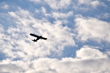 Fototapeta na wymiar Plane in Cloudy Sky