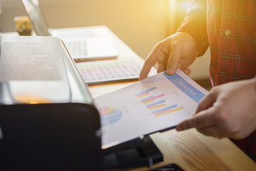 Businessman analyzing investment charts and business plan with printer. Accounting,Business People Planning Strategy Analysis Office Concept,vintage color
