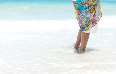 Woman walks towards the beautiful beach