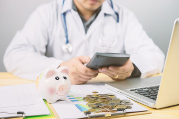 money in hospital finance relationships concept ,Doctor with piggy bank wanting payment Savings Pay...