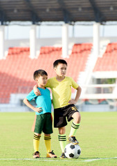 Obraz premium Boy and football in the football grass field