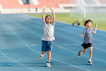 Boy running on the blue track