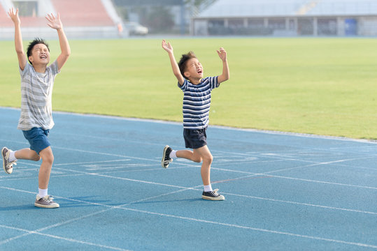 Boy running on the blue track
