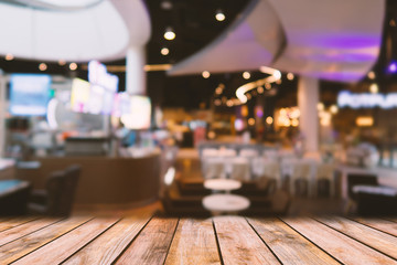 perspective wooden surface top view with blurred restaurant background.