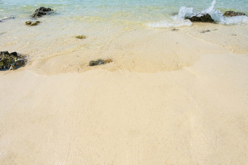 Soft wave on sandy and stone on the beach background