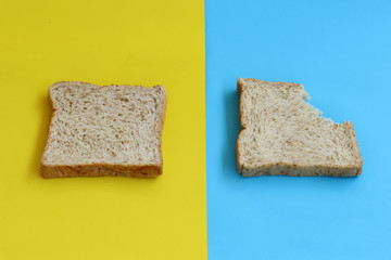Bread sheets on yellow and blue paper background. minimal food concept.