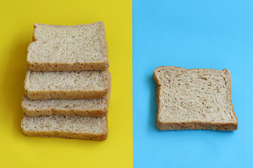Bread sheed Stacked on yellow and blue paper background. minimal food concept.
