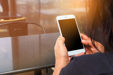 Women sitting and using smartphone to connecting with sunlight background. concepts for business connect, meeting, outing, co-work.