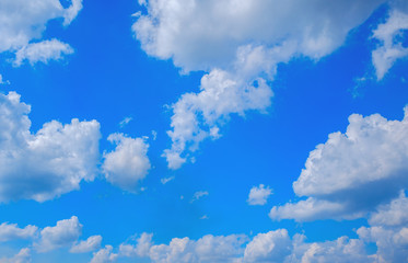 Obraz na płótnie Canvas Clouds float over ground with bright blue sky background