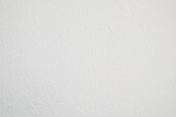 Pattern of white emulsion paint on a piece of plywood.