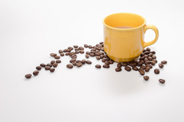 coffee beans and  yellow coffee cup isolated on white background