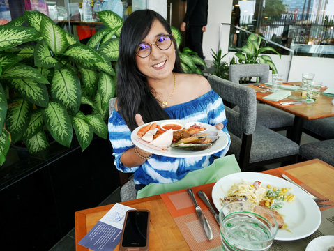Thai woman show cuisine on plate before eat