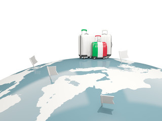 Luggage with flag of italy. Three bags on top of globe