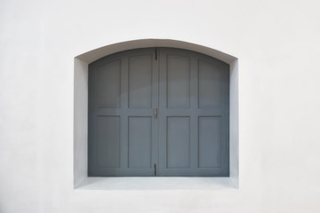 Classic grey window are close on white wall background