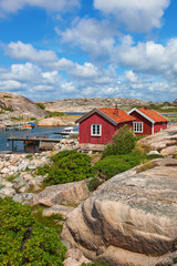 Fototapeta na wymiar Red cottages by the bay on the Swedish west coast