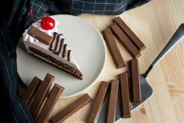 closeup delicious sweet dessert slice chocolate cherry on brown cream chocolate sponge cake