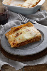 Lasagna Bolognese on a rustic table