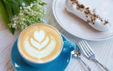 Coffee and eclair the rustic background. Concept and idea