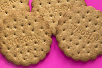 Round whole-grain crackers on colored background