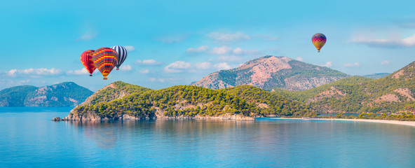 Hot air balloon flying over spectacular oludeniz lagoon
