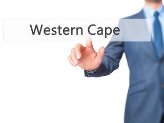 Western Cape - Businessman hand pressing button on touch screen interface.