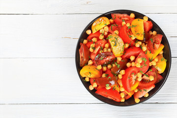 vegan chickpea tomato salad in black bowl
