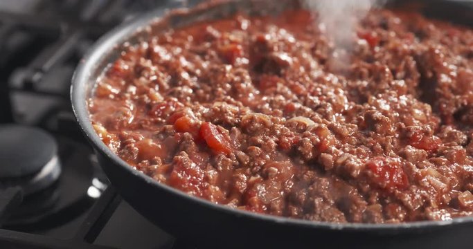 Slide shot of cooking bolognese sauce in pan, 4k 60fps prores footage