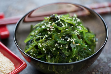Close-up of seaweed salad topped with sesame seeds, selective focus, horizontal shot