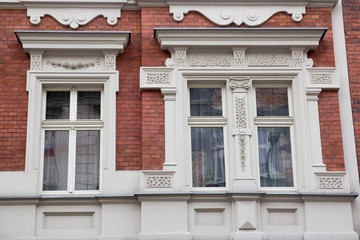 Three vintage designer window on the facade of the old brick house