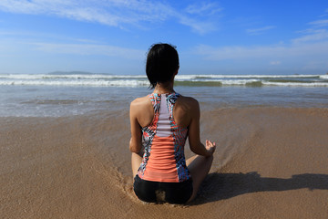 Fototapeta na wymiar Young fitness woman wear swimsuit practice yoga on the beach