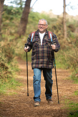 Portrait of a healthy senior attractive man hiking along the cost
