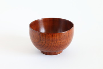 Wooden bowl (owan) isolated on white with natural shadows