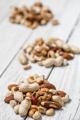 different nuts on white wooden background ,