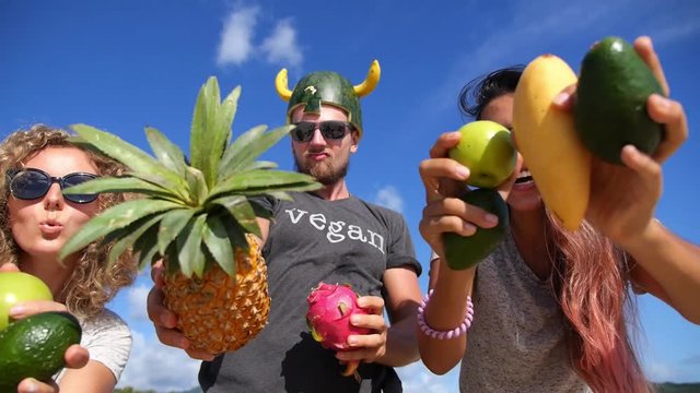 Group of Young People Having Fun With Fruits Against Blue Summer Sky. Slow Motion. HD, 1920x1080.