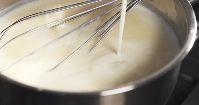 Slide shot of preparing bechamel sauce milk pour, 4k 60fps prores footage
