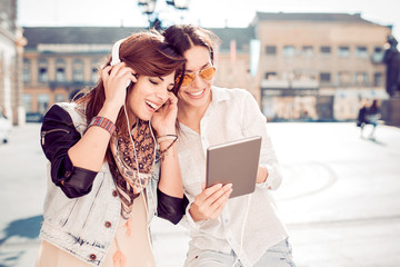 Fototapeta premium Two friends listening to music