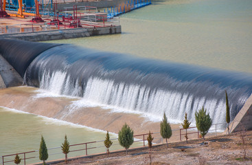 Water cascading out over the edge of a small dam