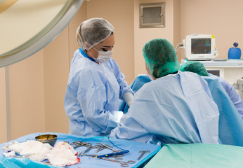 Surgical team performing surgery operation. Doctor  performing surgery using sterilized equipment