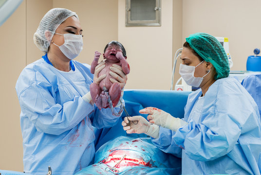 Surgical team performing surgery operation. Doctor  performing surgery using sterilized equipment